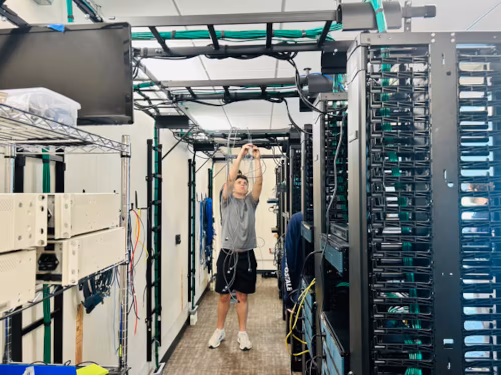 Organizing cables in a data center rack during a workshop